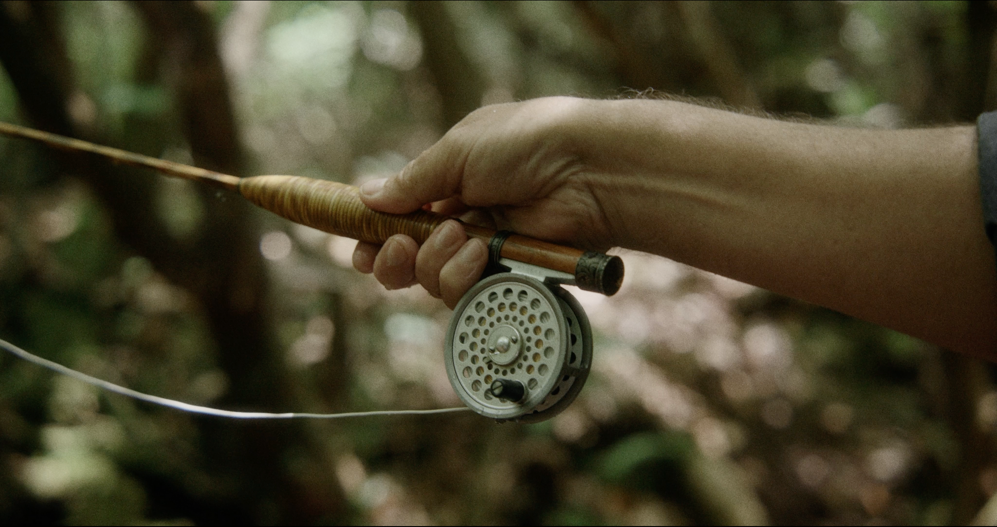 How does the action of a bamboo fly rod compare to graphite?
