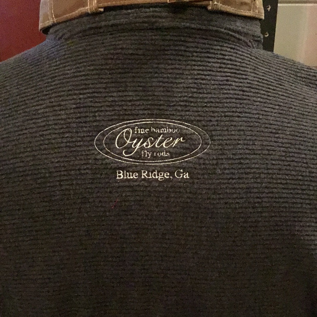 Simms Rivershed Full Zip in black featuring Oyster fly rods logo.