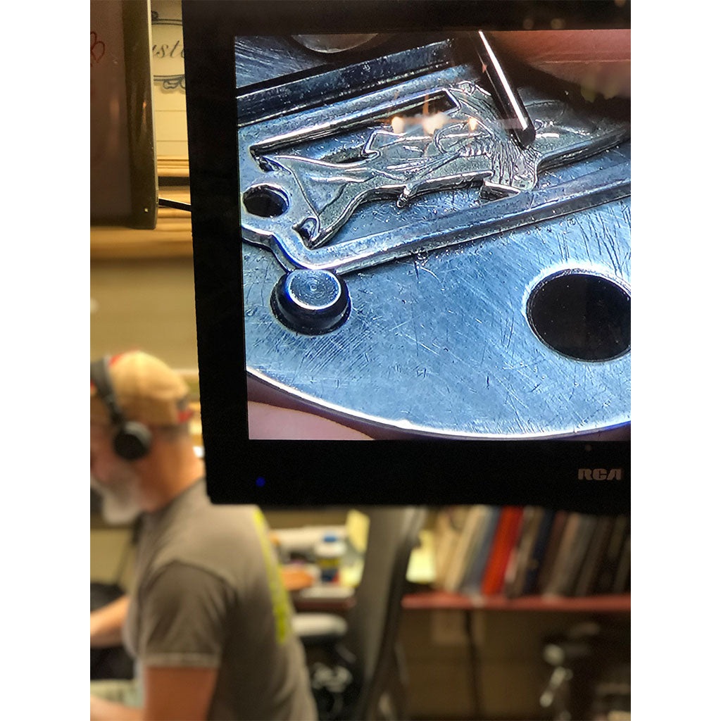 Bill Oyster hand engraving trout for sight line provisions collaboration cast