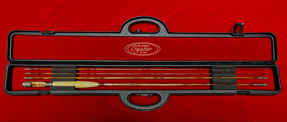 8' 5wt bamboo fly rod displayed in rigid carrying case with Oyster Bamboo logo and red interior.
