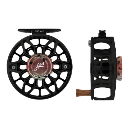 Ported black fly fishing reel with rainbow trout drag knob and 'Abel' branding on a white background 