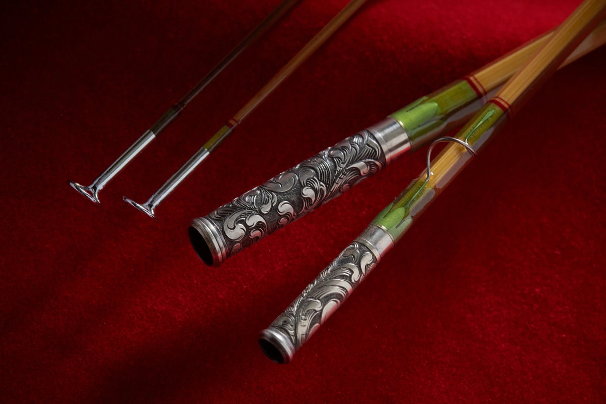Bamboo fly rod with hand engraved relief scroll on nickel silver ferrules.