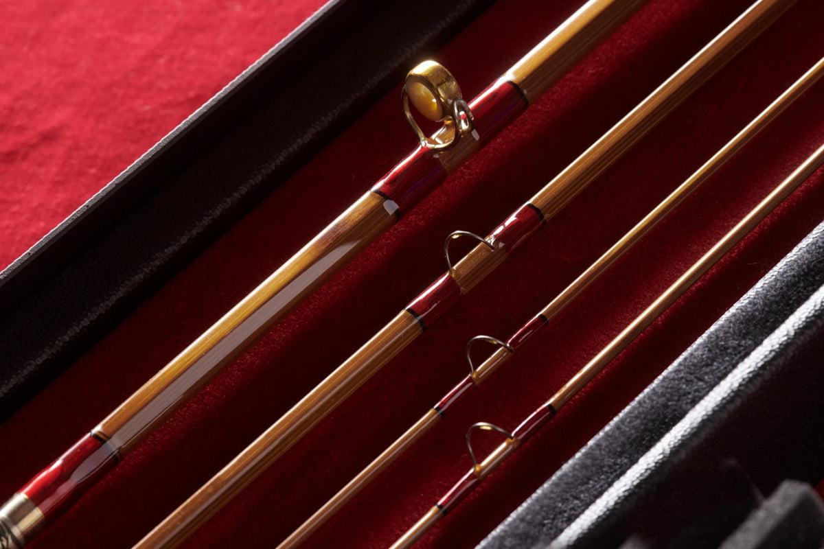 Close-up shot of agate guide on bamboo fly rod with red accents. 