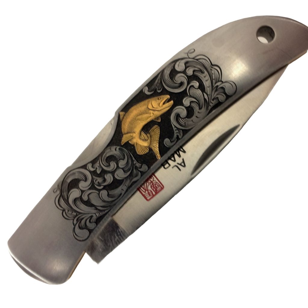 gold trout hand engraved on al mar knife by bill oyster bamboo fly rod.jpg