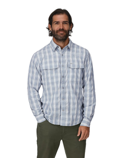 A man wearing Simms Big Sky long sleeve fishing shirt in bimini blue plaid.