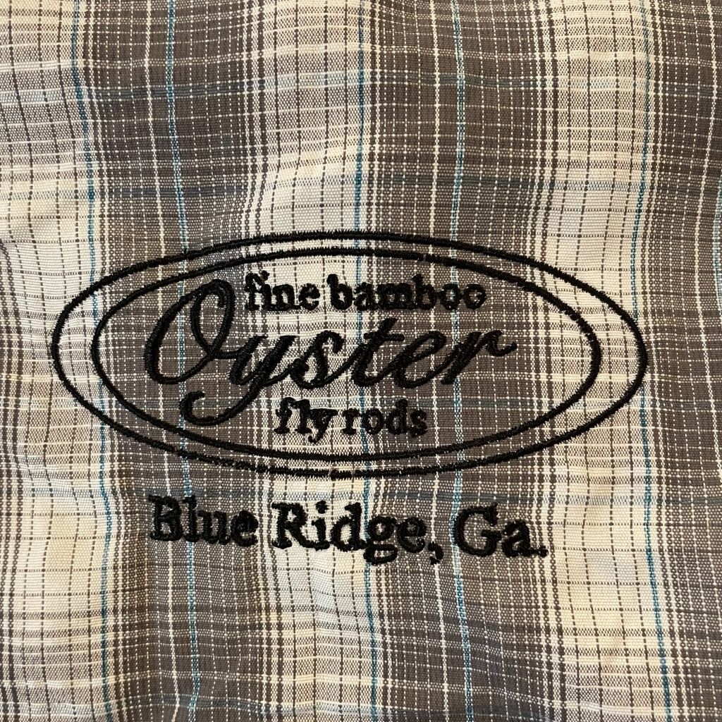 Simms Big Sky Short Sleeve Shirt in steel/pool plaid featuring Oyster fly rods logo.