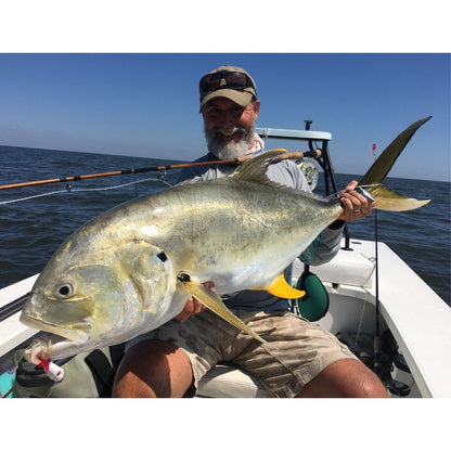 bill oyster with large fish caught on his saltwater oyster bamboo fly rods